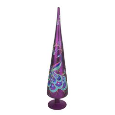 a purple vase with a blue and green design on the top is standing in front of a white background