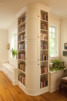 a room with bookshelves and wooden floors