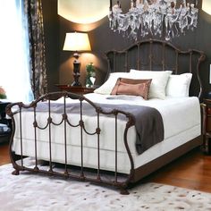 a bedroom with a bed, nightstand and chandelier