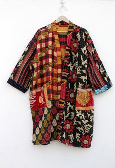 This is a new style in jacket. Fitted and fluttering it's a classic long kimono with belt and a big collar but made in a vintage kantha quilt upcycled from a vintage quilt. It's a combination of two worlds and it translates easily because of the denim color. Wear it whenever you would wear a denim jacket. Much more interesting! It's one hundred percent cotton. It can also be used as a reversible format. Jacket made with vintage kantha quilt fabric which is 4-5 layer or cotton fabric and old more Bohemian Long Sleeve Patchwork Kimono, Bohemian Long-sleeved Floral Patchwork Outerwear, Bohemian Long Sleeve Outerwear With Floral Patchwork, Bohemian Long Sleeve Floral Print Outerwear, Fall Patchwork Long Kimono, Bohemian Multicolor Outerwear With Floral Patchwork, Multicolor Floral Print Outerwear For Festival, Fall Patchwork Kimono With Kimono Sleeves, Traditional Printed Long Sleeve Outerwear