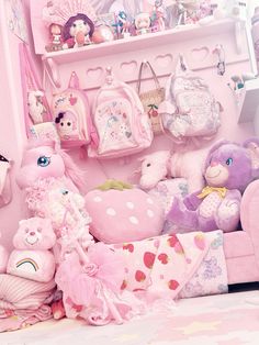 there are many stuffed animals on the shelf next to each other in this pink room