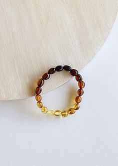 the bracelet is made out of glass beads and has a yellow bead around it