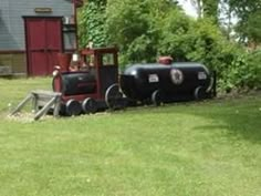 an old fashioned train is parked in the yard