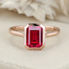 Experience the radiance of red with our Emerald Cut Lab Grown Ruby Engagement Ring in rose gold, a perfect solitaire choice for July birthstone enthusiasts. Red Ruby Solitaire Rings, Luxury Timeless Ruby Ring With Bezel Setting, Modern Ruby Engagement Ring, Ruby Bezel Engagement Ring, Rose Gold Bezel Set Ruby Ring In 14k Gold, Classic Rose Gold Ruby Ring For Proposal, Red Ruby Promise Ring With Bezel Setting, Red Ruby Ring With Bezel Setting For Promise, Classic Ruby Ring In 14k Rose Gold