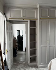 an empty bedroom with white walls and closets