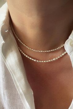 Lovely dainty freshwater pearl necklace! Simple yet feminine, this necklace features tiny seed natural white pearls. It is perfect on its own or layered with some of your favourite necklaces. You will love it! With its classic and vintage vibe this genuine pearl necklace would be a great piece for everyday or a boho wedding. #pearls #necklacesjewelry #daintyjewelry #daintynecklace Delicate Beaded Necklace In Pearl White With Pearl Chain, Dainty Everyday Beaded Pearl Necklace, White Pearl Necklace For Everyday, Dainty Pearl White Necklace, Dainty White Pearl Necklace, Everyday White Pearl Necklace, Everyday Delicate Beaded Necklace With Pearl Pendant, Delicate Everyday Beaded Necklace With Pearl Pendant, Dainty Pearl White Beaded Necklaces With Pearl Pendant