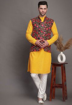 Faux Georgette Kurta in Yellow.This Readymade attire is Enhanced with Resham and Zari Work. Crafted in Chinese Collar Neck and Full SleeveAvailable with a Cotton Pajama in White and an Art Matka Silk Nehru Jacket in BlackDo note: Footwear shown in the image is for presentation purposes only. Half to one inch may vary in measurement. (Slight variation in actual color vs. image is possible)  We sell all kinds of menswear. Mens Kurta | Mens Kurta Pajama | Mens Sherwani | Mens Sherwani Sets | Tradit Festive Traditional Outerwear With Embroidered Sleeves, Yellow Bandhgala With Resham Embroidery Long Sleeve, Yellow Long Sleeve Bandhgala With Resham Embroidery, Fitted Yellow Nehru Jacket For Festivals, Fitted Chikankari Embroidered Outerwear For Festivals, Fitted Chikankari Embroidery Outerwear For Festivals, Gold Embroidered Nehru Jacket For Festivals, Long Sleeve Nehru Jacket With Gold Embroidery For Festivals, Bollywood Style Embroidered Winter Sets