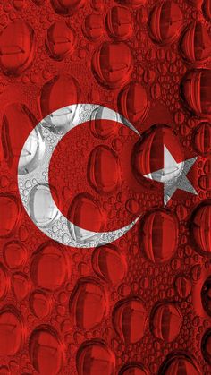 the flag of turkey is depicted on water droplets in this artistic photo, it appears to be made out of soda cans