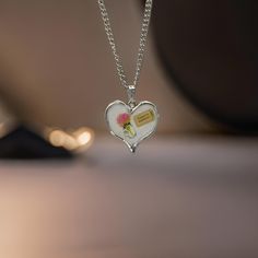 ✨ *Are you ready to explore the world, or perhaps, gift someone special the reminder to chase their dreams? This beautiful heart-shaped pendant necklace is a gentle nod to adventure, adorned with a delicate floral illustration and a whimsical 'Ticket to Anywhere' tag.* ✨ **Product Features - **Design A silver-tone heart pendant with a stunning floral decal, featuring a soft pink flower in a vase and a'Ticket to Anywhere' decal - **Material High-quality silver alloy, durable and lightweight, perf Spiritual Charm Necklace For Valentine's Day Gift, Nickel-free Heart Necklace For Valentine's Day Keepsake, Meaningful Nickel-free Necklaces For Valentine's Day, Heart-shaped Necklace For Birthday Gift, Spiritual Heart Necklace As A Valentine's Day Gift, Meaningful Heart-shaped Necklace For Birthday Gift, Meaningful Heart Necklace For Birthday Gift, Valentine's Day Gift Charm Necklaces, Valentine's Day Keepsake Necklaces With Charms