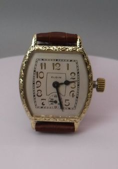 This beautiful Elgin watch looks just like it did when it came home from a Jewelry store in 1928.  The watch is simply amazing. This is an Elgin, 15 Jewel, Art Deco Style Wristwatch, circa. 1928.  This watch has an Elgin 3/0s size, circa. 1928, Grade 464, model 2, 15 Jewel movement.  This is one of the finest wristwatch size movements Elgin made at that time and has a very precise screw adjustment regulator for very fine regulating of the balance spring.   The watch has a perfect white linen col Elegant Collectible Watch With Rectangular Dial, Classic Watches With Rectangular Dial For Collectors, Classic Collectible Watch With Rectangular Dial, Vintage Analog Watch With Rectangular Dial, Vintage Rectangular Chronometer Watch, Vintage Watch With Subdials And Rectangular Dial, Classic Collectible Analog Watch Accessories, Timeless Engraved Round Dial Jewelry And Watches, Vintage Rectangular Watch With Subdials