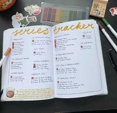 an open notebook with the contents of a recipe book on top of it, surrounded by markers and pencils