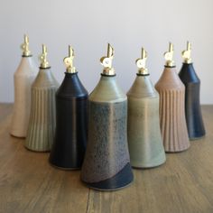 five ceramic vases with musical notes on them sitting on a table top, lined up in a row