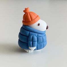 a small toy with a hat and scarf on it