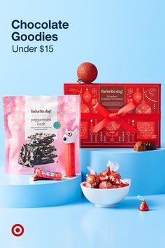 chocolate goodies under $ 15 are on display in front of a bowl of candy