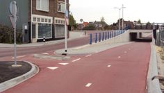 an empty street with no cars on it and buildings along the side of the road