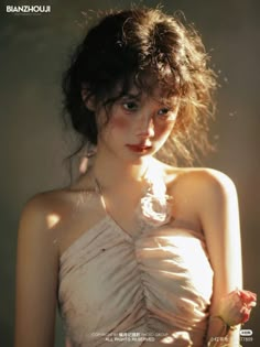 a young woman in a white dress holding a flower and looking at the camera with an intense look on her face