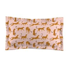 a pink pillow case with gold leopards on the front and back, along with a white background