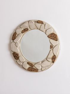 a round mirror with rocks on it