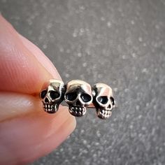 ♡ Be Inspired: Channel a bold and edgy vibe with the 3 Skulls Ear Cuff, expertly crafted from 925 Sterling Silver. This striking accessory features three intricately detailed skulls in a row, perfect for those who embrace gothic, biker, or punk-inspired style. Whether you're making a statement at a concert or adding a rebellious touch to your everyday look, this ear cuff is the ultimate piece to showcase your unique personality. ♡ Details: Material: 925 Sterling Silver Plating: Oxidized + E-coat Edgy Skull Ring Gift, Grunge Style Sterling Silver Jewelry Gift, Silver Skull Shaped Single Earring, Edgy Silver Skull Ring As Gift, Edgy Silver Skull Ring For Gift, Nickel-free Punk Piercings For Gift, Edgy Silver Skull-shaped Jewelry, Adjustable Edgy Skull Ring Gift, Adjustable Edgy Skull Ring As Gift