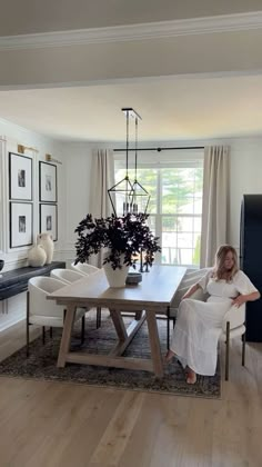 a woman sitting at a table in a living room