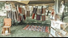 an outdoor market with towels and rugs on display