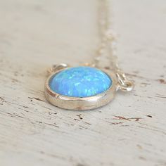 Blue Opal Pendant Necklace,Opal silver Necklace,Gemstone Necklace,Opal Necklace,Gift for Mom,Delicate Necklace,Blue Opal Necklace JewelrySpacial Gift!So dainty and classic tiny everyday opal necklace, great idea for Mother's Day.Beautiful 10mm lab opal pendant hangs on a delicate sterling silver chain .The Opal is October birthstone and considered to be the stone for luck :)This necklace is perfect for yourself, giving as a special gift, or bridesmaid necklaceSo simple and yet will be stunning on your neck!*Model wearing 16 inch length*Opal stone size- 10mm All my jewelry are packed in an elegant gift box.If you want to give it as a gift you can specify the address and I'll be happy to send it on your behalf. Opal Birthstone Necklaces, Opal Birthstone Round Necklaces, Round Opal Birthstone Necklaces, Silver Opal Jewelry With Round Stone, Blue Opal Nickel-free Jewelry, Nickel-free Blue Opal Jewelry, Blue Opal Gemstone Necklaces, Blue Opal Gemstone Necklace, Blue Opal Round Necklace