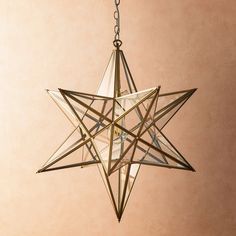 a star shaped light hanging from a chain