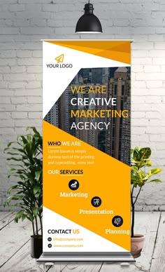 a roll up banner with the words we are creative marketing agency in yellow and white