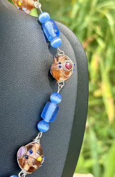 a beaded necklace with glass beads and charms