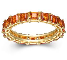 a yellow gold ring with orange stones