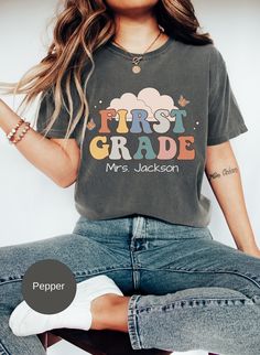 This Personalized First Grade teacher shirt is the ideal gift for a 1st grade teacher who loves their job. So if you are looking for a unique gift for a friend or family member then this tee is perfect. Our T-shirts are printed in the highest quality inks and the material is extremely comfortable. 5 COLORS TO CHOOSE FROM, SEE COLOR CHART 7 SIZES AVAILABLE: S-4XL  If you look at the listing photos, you will see some of the colors this shirt comes in, I have chosen the colors that I feel the shirt Personalized T-shirt For Teacher Appreciation And Back To School, Personalized Teacher Appreciation T-shirt For Back To School, Personalized Tops For Back To School, Cute T-shirt With Name Print For Teacher Appreciation, Personalized Cotton Tops For Back To School, Cotton T-shirt For Teaching, Back To School, Personalized Tops With School Spirit For Back To School, Personalized Tops For Back To School With School Spirit, Personalized Crew Neck Tops For Back To School