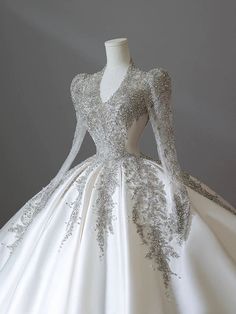 a white ball gown with silver sequins on the bouncy neckline