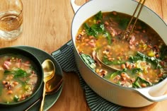 a bowl of soup with chopsticks in it on top of a wooden table