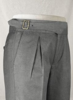 These men's customized grey wool Gurkha pants combine classic elegance with modern functionality, making them a versatile choice for any wardrobe. Featuring an adjustable buckle front and deep pleats, they offer both comfort and style, ideal for business, office, or formal occasions. Crafted from high-quality wool, these pants provide warmth and durability while maintaining a refined, tailored look. The unique Gurkha design, inspired by military heritage, adds a touch of sophistication, making t Gray Dress Pants With Pockets For Formal Occasions, Formal Gray Dress Pants With Pockets, Gray Formal Dress Pants With Pockets, Tailored Gray Bottoms With Belt Loops, Tailored Gray Pants With Belt Loops, Gray Fitted Dress Pants With Belt Loops, Classic Gray Semi-formal Pants, Fitted Gray Pants For Tailoring, Business Gray Bottoms With Belt Loops