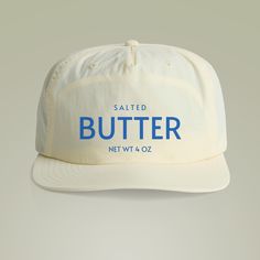 This Funny Butter Surf Style Cap is perfect for anyone looking to add a touch of humor to their beach wardrobe. Made with 100% recycled nylon, it offers a soft and comfortable fit. The quick dry fabric is ideal for long days under the sun, making it a must-have accessory for surfers and beachgoers. This cap is relevant for beach vacations, surfing trips, and outdoor summer activities. Product features - 100% recycled nylon for a soft and comfortable fit - Mid profile and unstructured snapback design for a casual look - Quick dry fabric ideal for outdoor activities - Tonal under-peak lining for added style - One size fits all for easy wear Care instructions - Wipe clean with a damp cloth. Surfer Hat, Outdoor Summer Activities, Outdoor Hut, Surf Hats, Beach Wardrobe, Outdoor Hat, Surf Trip, Green Lake, Surf Outfit