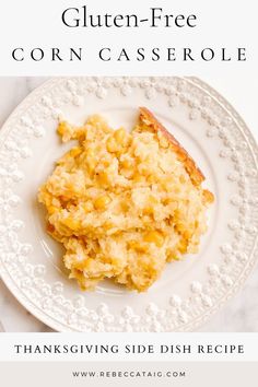 a white plate topped with corn casserole on top of a table