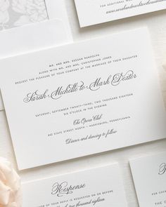 the wedding stationery is laid out on top of each other