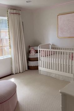 a baby's room with pink and white decor