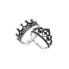 two silver rings with black diamonds on each one and a crown ring in the middle