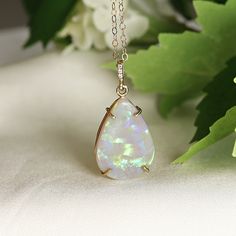 "Pear cabochon shaped beautiful Australian opal pendant necklace. It's featured on 14k yellow solid gold handmade prong setting, diamond bail and 14k yellow solid gold chain. Opal is pear shaped cab cut and unique. DETAILS  Opal is genuine Australian opal and pear shaped. Pendant size : 21.5mm height, 14.5mm width Bails has 3 diamonds total 0.01 ct.  It's coming with 16' to 18\" adjustable 14k solid gold chain.  All our raw materials are sourced from US-based companies for the quality and safety Fine Jewelry Opal Cabochon Necklace, Elegant Ethiopian Opal Cabochon Necklaces, Formal Opal Necklace With 17 Jewels, Opal Teardrop Pendant Necklace With Gemstone, Teardrop Cabochon Necklace For Anniversary, Anniversary Teardrop Cabochon Necklace, Anniversary Cabochon Teardrop Necklace, Formal Opal Teardrop Pendant Jewelry, Pear-shaped Opal Necklaces For Gifts