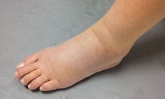 a close up of a person's bare foot on the ground with no shoes