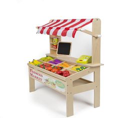 a wooden toy farm stand with fruits and vegetables