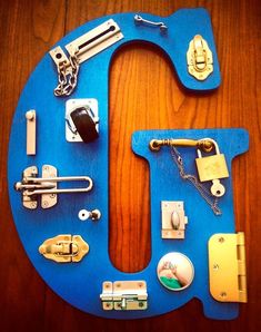 the letter u is made up of different types of locks and hardware on a wooden surface