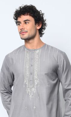 Introducing our distinguished Men's Thobe adorned with exquisite Islamic ornament embroidery on the front chest, meticulously crafted to embody the essence of tradition and style. This exceptional garment seamlessly blends cultural heritage with contemporary sophistication, making it a standout choice for any occasion. Featuring Front button down placket from neck to chest, Straight sleeves and Dual Pockets. This Thobe offers both functionality and style. Perfectly positioned for convenience, these pockets provide ample space for storing essentials while maintaining the sleek silhouette of the garment. Crafted from premium quality fabric, our Men's Thobe ensures unparalleled comfort and durability, allowing you to move with ease while exuding confidence and grace. Whether worn for religiou Traditional Fit Kurta With Intricate Embroidery For Eid, Eid Straight Kurta With Tonal Embroidery, Eid Kurta With Intricate Embroidery Traditional Fit, Classic Long Sleeve Traditional Wear For Eid, Traditional Long Sleeve Tops With Tonal Embroidery, Formal Floral Embroidered Kurta For Eid, Festive Traditional Wear With Tonal Embroidery For Eid, Eid Traditional Wear With Embroidered Border, Eid Festive Traditional Wear With Tonal Embroidery