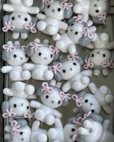 many white and gray teddy bears with pink bows