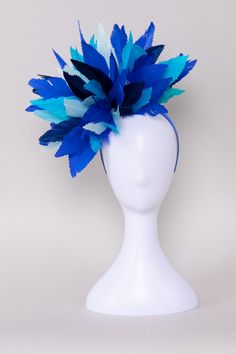 Step into the depths of elegance with the Crew's Deep Sea Blue Fascinator! Crafted with an array of enchanting shades of blue feathers, this exquisite accessory captures the allure of the ocean's depths. Whether you're attending a lavish Derby event or adding a touch of sophistication to your ensemble, this fascinator promises to make waves with its timeless charm and captivating hues. NO RETURNS/EXCHANGES due to the nature of the product (special occasions and headwear). Not all screens/lightin Blue Feather Fascinator For Summer, Blue Feathered Fascinator For Summer, Blue Feathered Summer Fascinator, Blue Feather Headpiece For Summer, Blue Feathered Headpieces For Summer, Blue Feathered Summer Headpieces, Blue Feathered Fascinator For Spring, Spring Blue Feathered Fascinator, Blue Feather Fascinator For Kentucky Derby