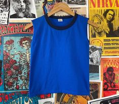 "Vintage kids 1980s blue two tone sleeveless ringer tank top shirt. Made of 100% cotton in the U.S.A. Is tagged a size medium, we estimate it to fit a kids 10, age 8/9, but please check measurements as this is an estimate. Has a small spot on back, but is in otherwise good, pre-owned condition. tag size | medium -- est. it to best fit kids size 10, age 8-9 *refer to measurements for sizing as this is an estimate measurements: chest -- 28\" total length -- 17\""