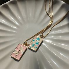 We collaborated with artist Julie Dreams to create the Tarot card necklace of our dreams. This necklaces features one kind artwork thoughtfully created by her just for us. We created this necklace in mind to pair with our Three of Cups Necklace (https://www.etsy.com/listing/1719373341/three-of-cups-tarot-pendant-necklace). Together, they make the perfect set of BFF necklaces.  Delicately detailed in enamel is our representation of the Queen of Wands card. This card is represents independence, ge Artistic Rectangular Necklace For Gifts, Artistic Rectangular Necklace For Gift, Artistic Rectangular Pendant Necklace As Gift, Artistic Rectangular Pendant Necklace For Gift, Artistic Pink Necklace For Gift, Artistic Enamel Necklaces As Gift, Artistic Square Pendant Necklace For Gift, Artistic Enamel Necklaces For Gifts, Three Of Cups Tarot