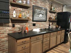 a brick wall behind a bar with liquor bottles on it