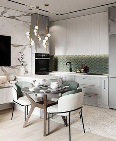 a modern kitchen with white cabinets and marble counter tops, along with a dining table set for four